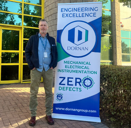 Man standing in front of the Dornan Mechanical Electrical Instrumentation headquarters